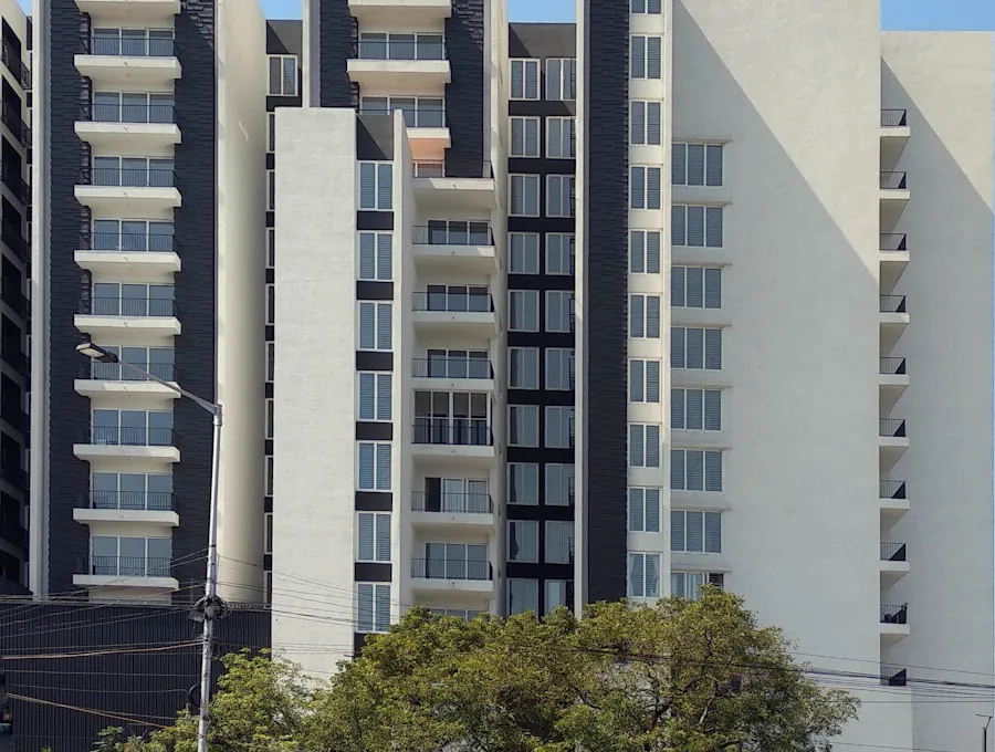 Pale blue apartment facade with stacked balconies