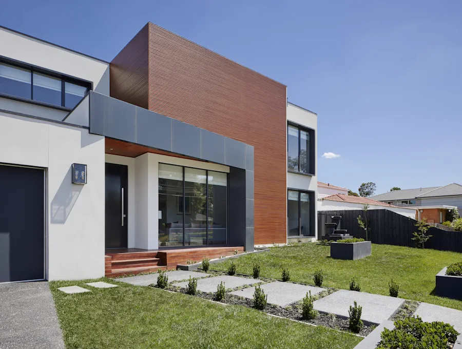 Modern two-storey house in dark timber and white render