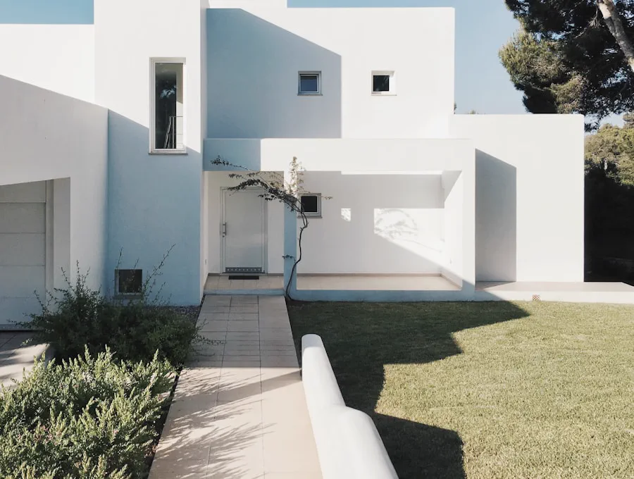 White stucco courtyard house with deep cut window openings