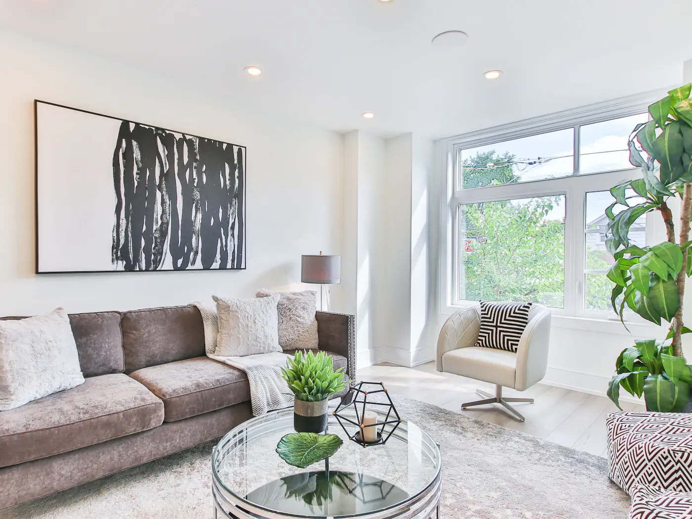 Bright living room with a grey sofa and a glass coffee table