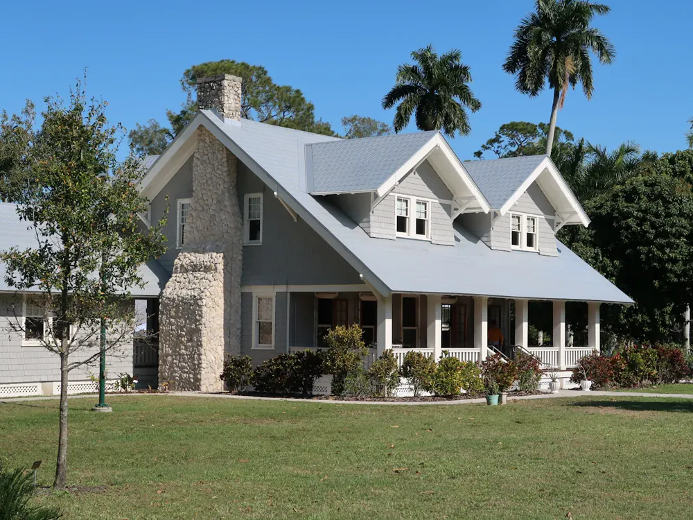 The house from the lawn, gables and a covered porch across the front
