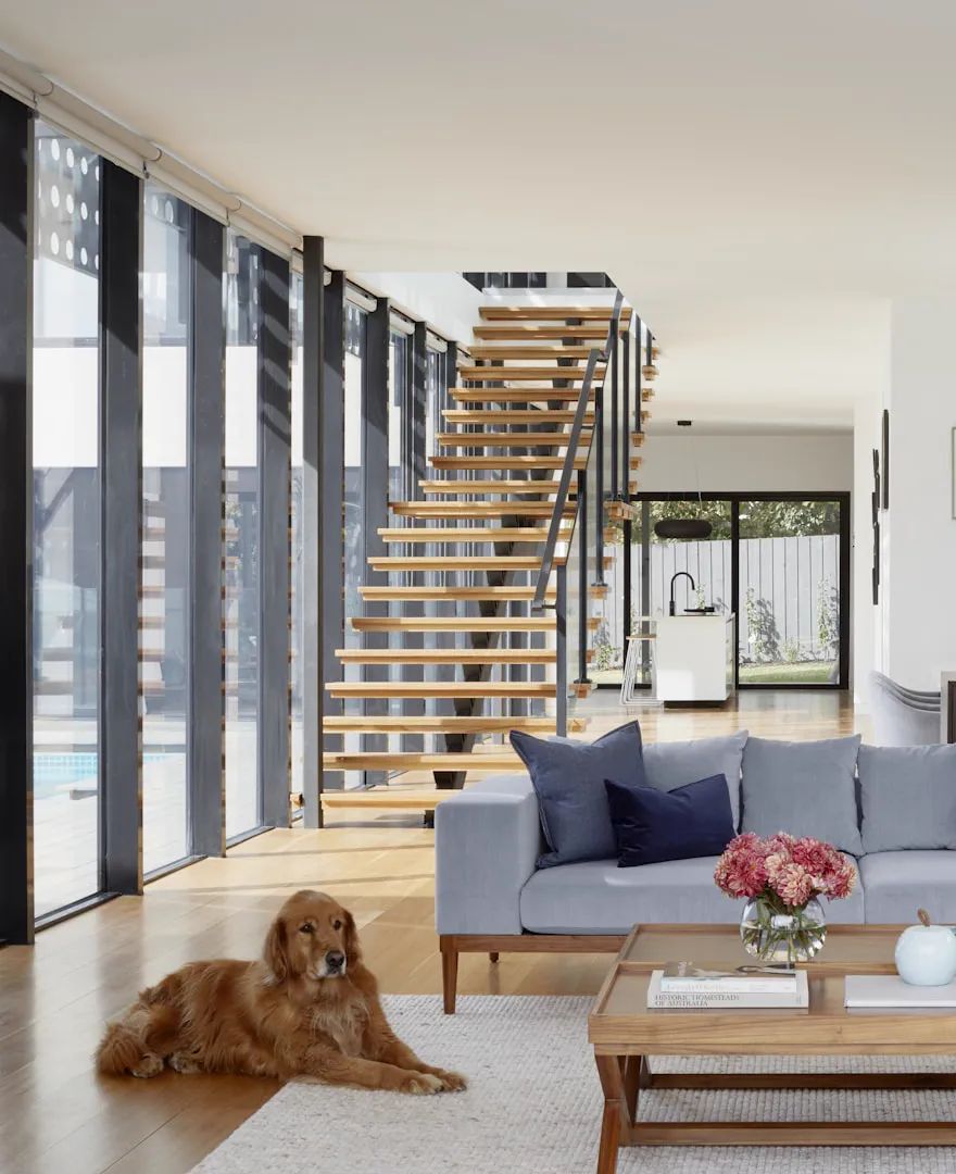 Living room with a staircase and afternoon light