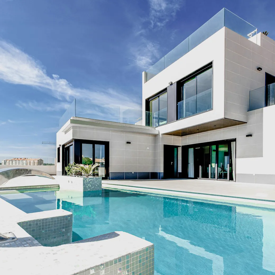 White modern house with a curved pool deck