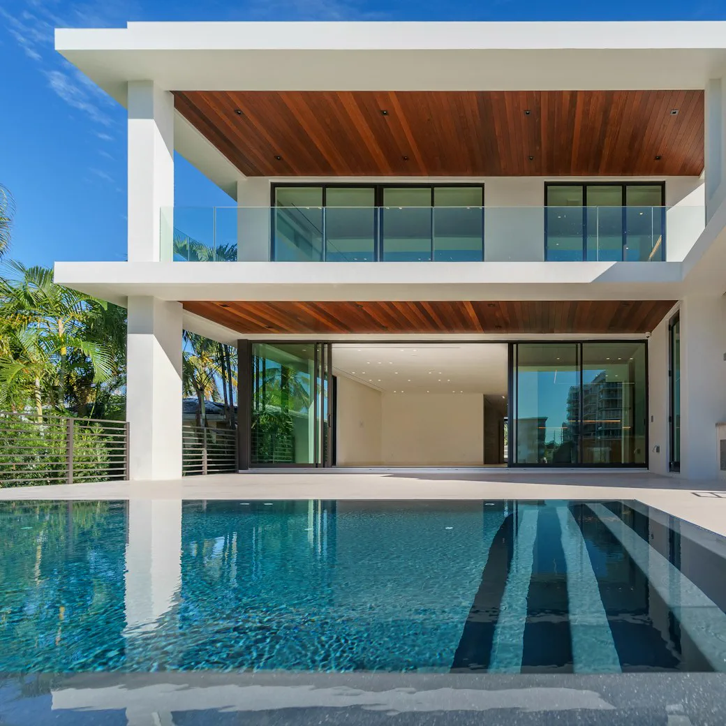 Villa with a long lap pool under a timber soffit